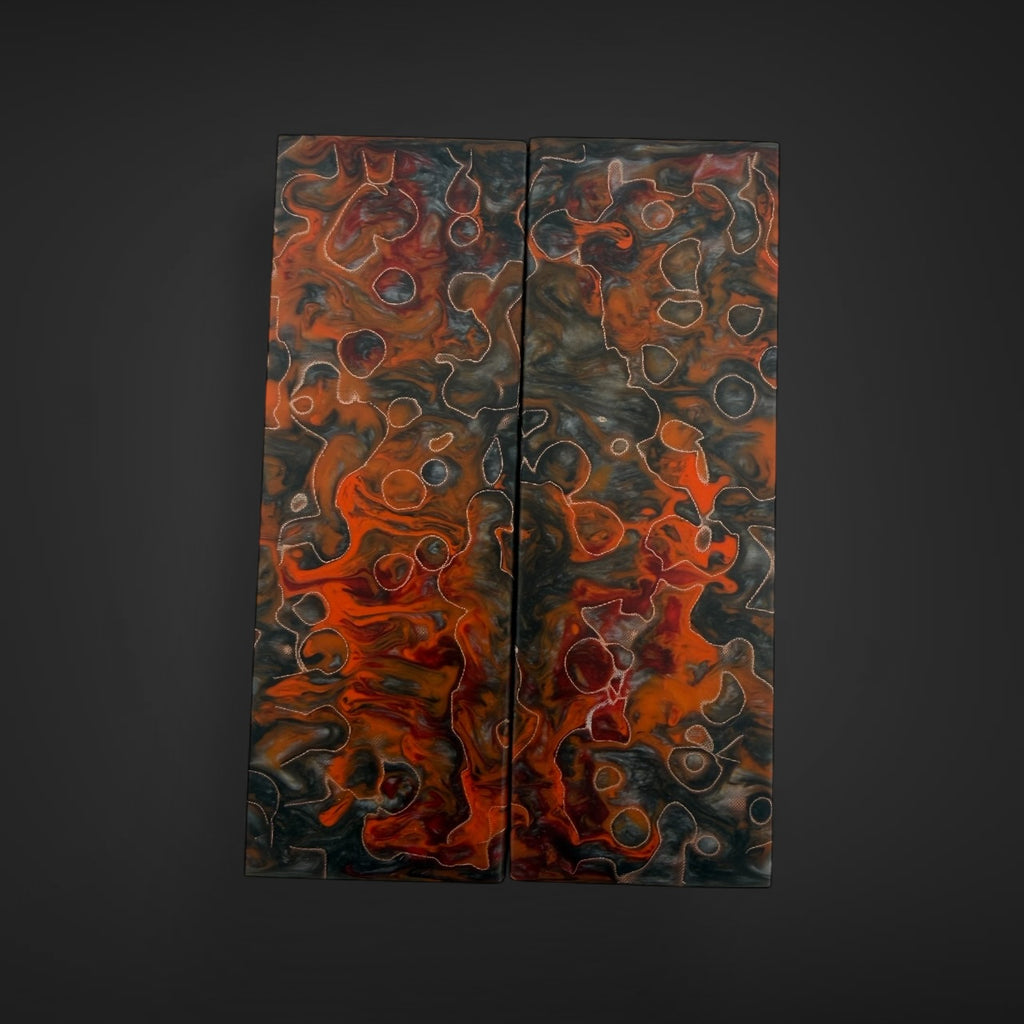 Beautiful custom CopperCore  magma knife scales Abstract dual-panel wall art with swirling marbled patterns in black, orange, red, and gray, displayed against a dark charcoal background.