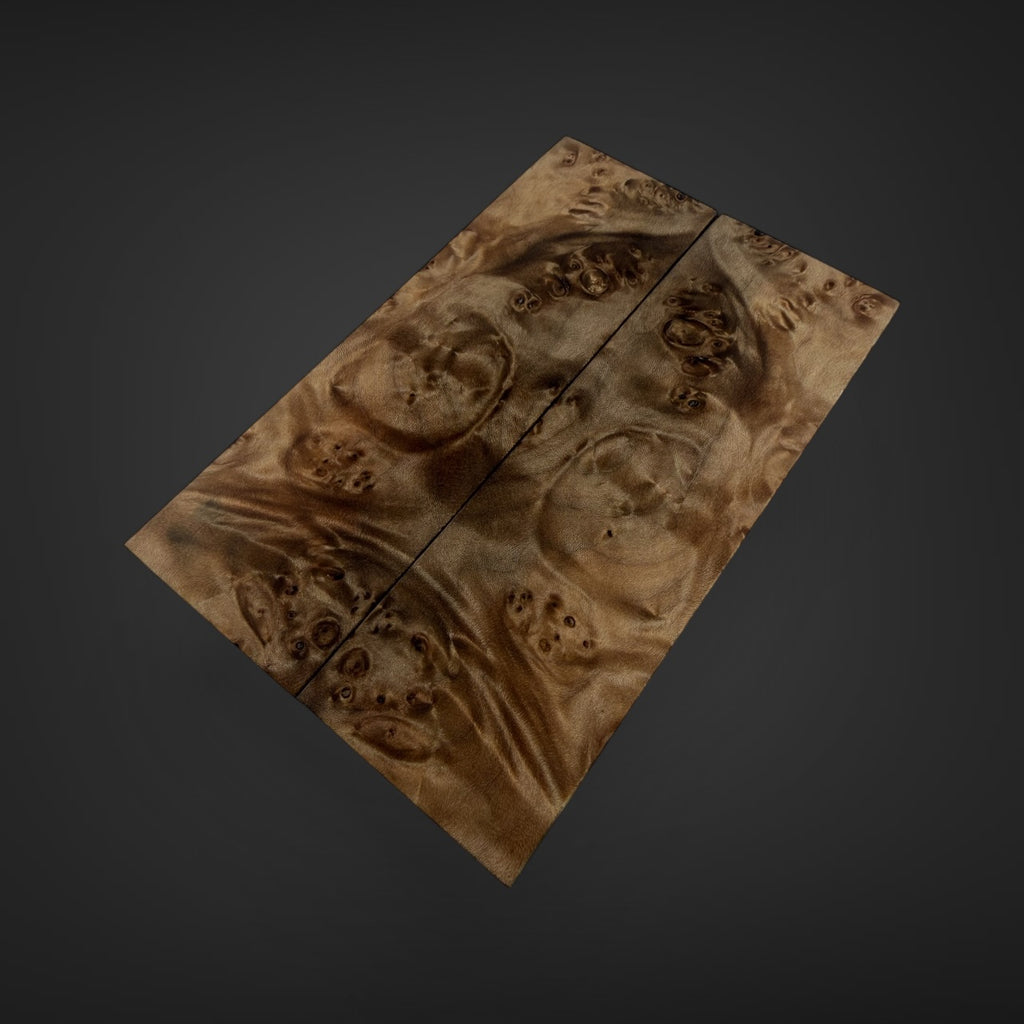 A rectangular wooden board or panel with a rich, swirling natural wood grain pattern in warm brown and tan tones, shown against a dark gray gradient background.