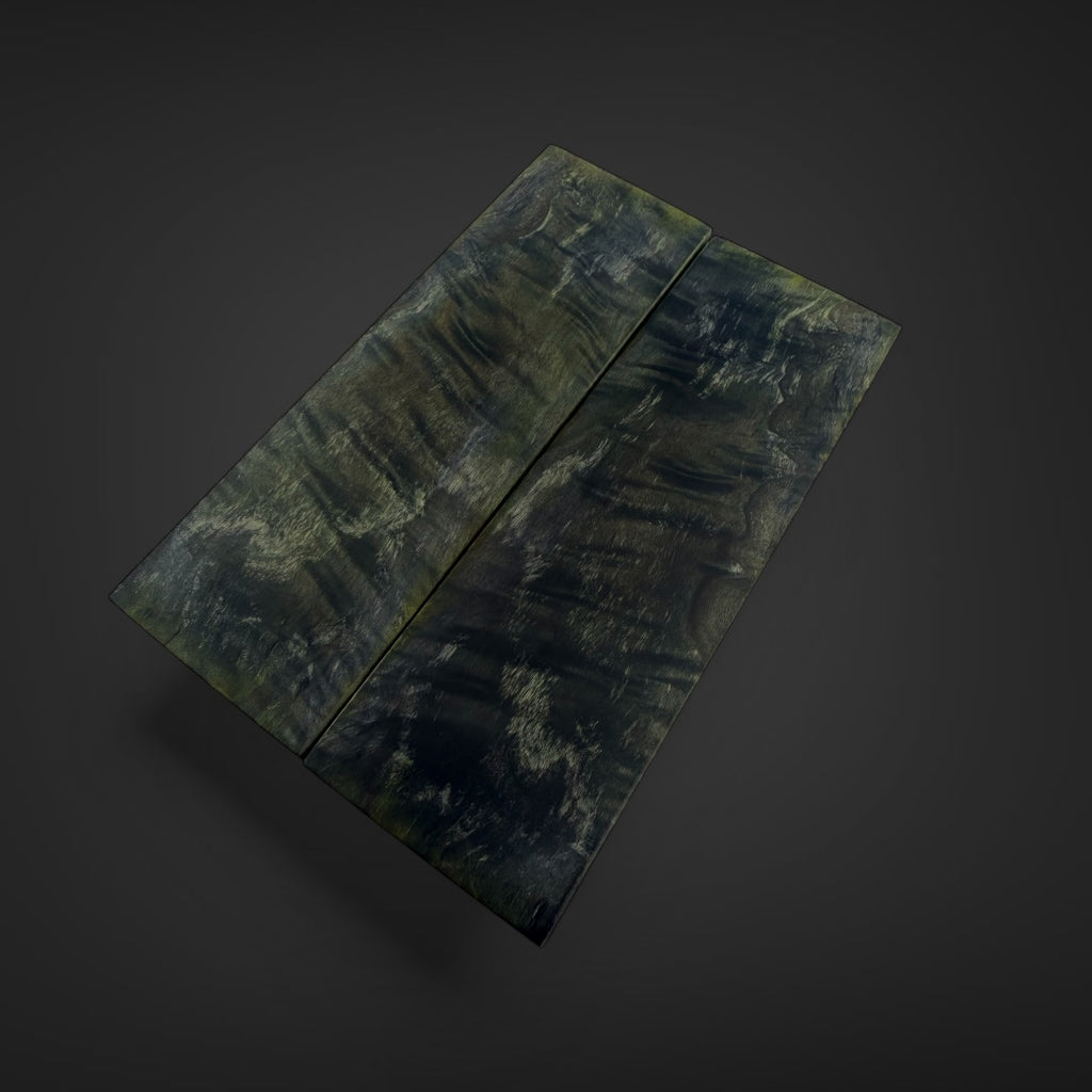 Two rectangular dark camouflage panels with a textured, mottled pattern of green, black, and gray, shown on a dark gray background.